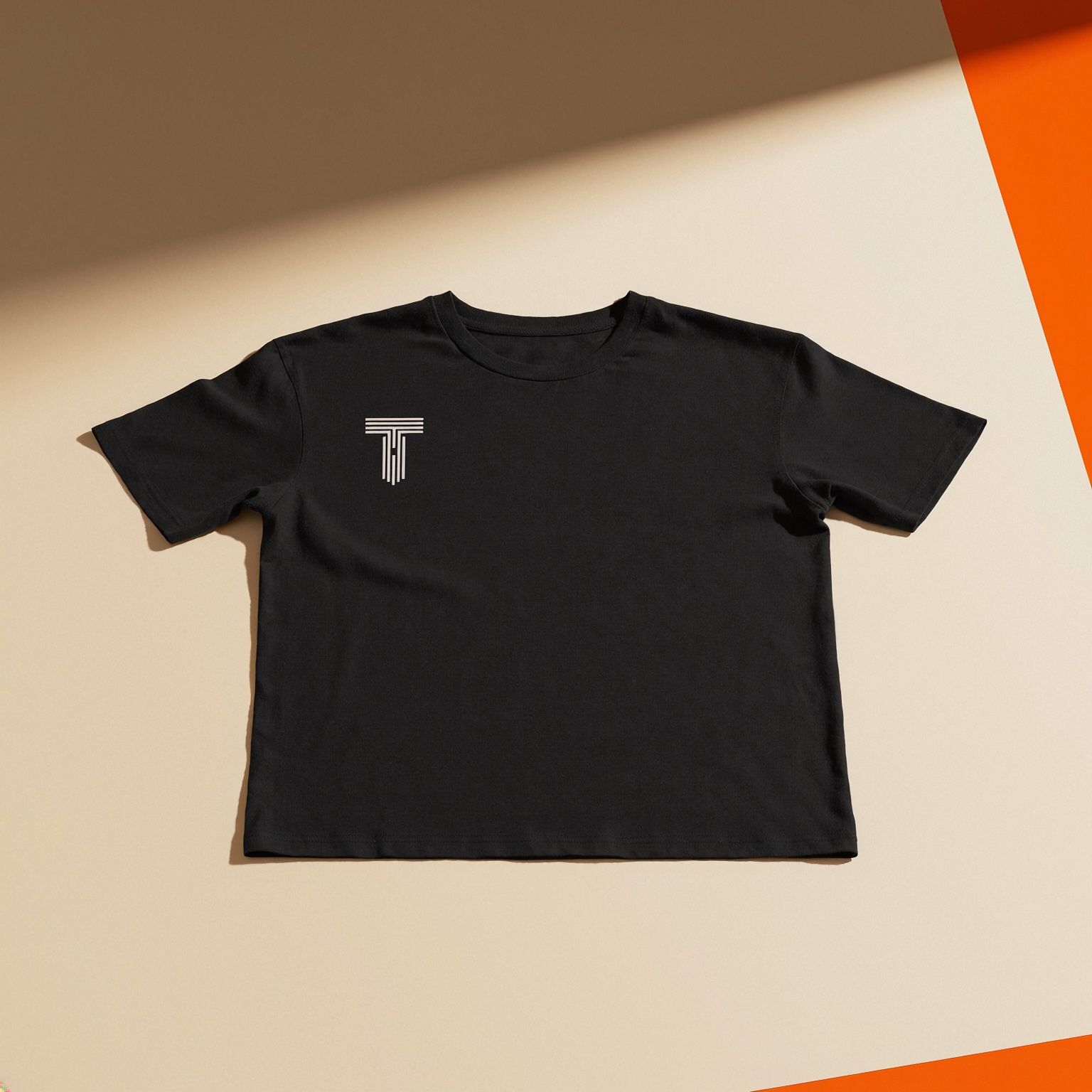 Black T-shirt with a small white Tecton Ink mark on the left chest